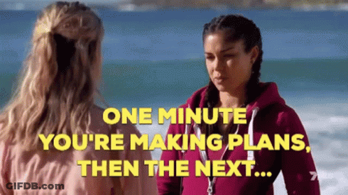 Two Women On Beach Saying One Minute You're Making Plans Then The Next GIF