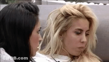 Two Women On Couch, One Messy Hairdo GIF