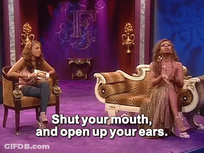 Two Women On Couch One Saying Shut Your Mouth And Open Your Ears GIF