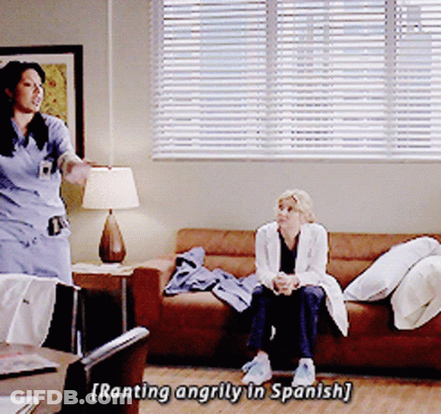 Two Women On Couch One Talking In Spanish GIF