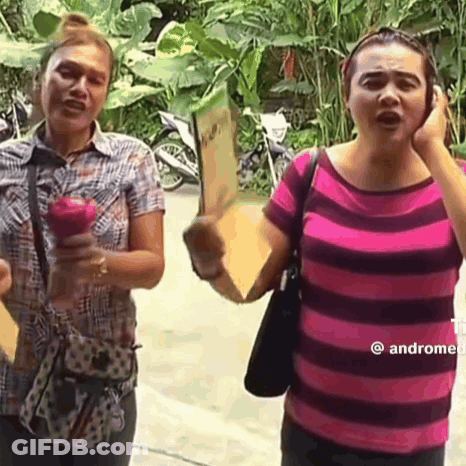 Two Women One Holding Apple One Holding Sign GIF