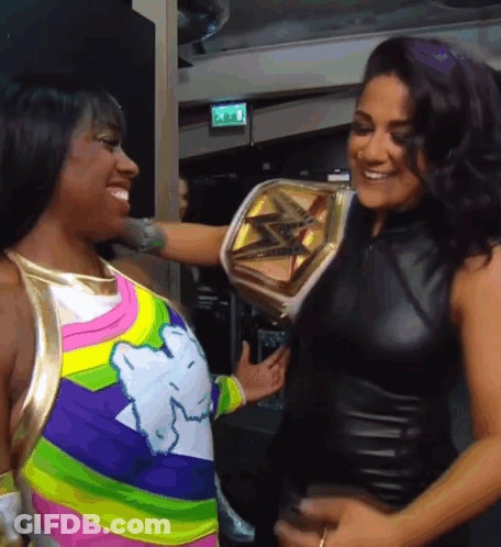 Two Women One Holding Championship Belt GIF