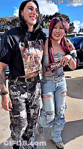 Two Women One Holding M&M's Candy Bar GIF