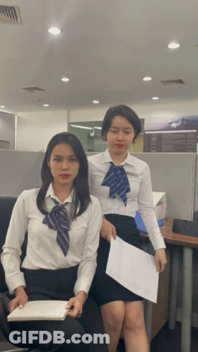 Two Women One Holding Paper GIF