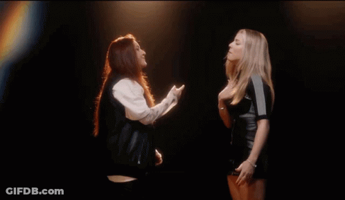 Two Women One Wearing ZZ Shirt GIF