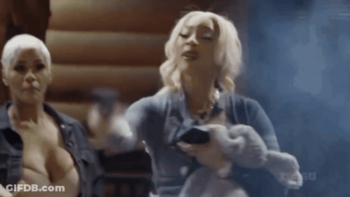 Two Women One With Stuffed Animal One With Phone GIF