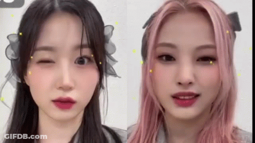 Two Women Pink Hair One Winking GIF
