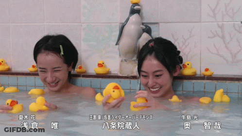 Two Women Playing With Rubber Ducks In Bathtub GIF