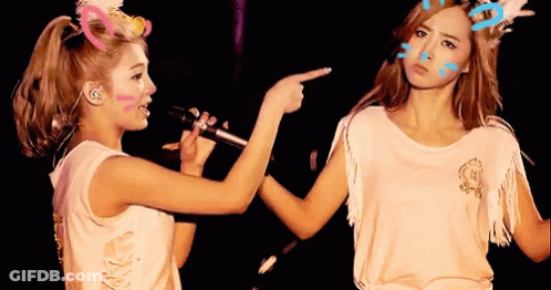 Two Women Pointing At Face GIF