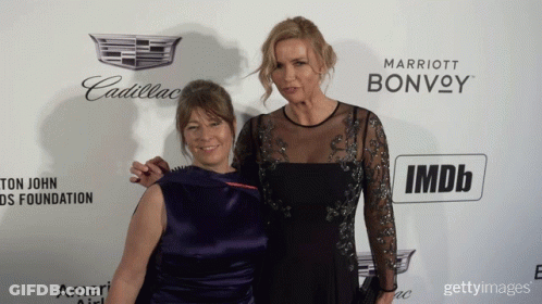 Two Women Pose On Red Carpet With Cadillac And Marriott Bonvoy Logo GIF