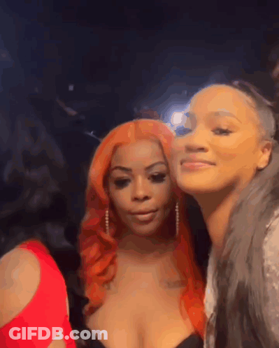 Two Women Posing In Dark Room One Red Hair GIF