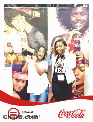 Two Women Posing In Front Of Coca Cola Ad GIF
