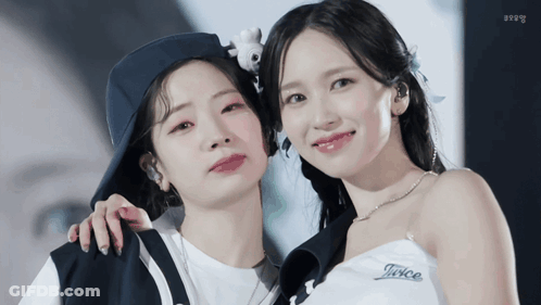 Two Women Posing, One In TWICE Shirt GIF