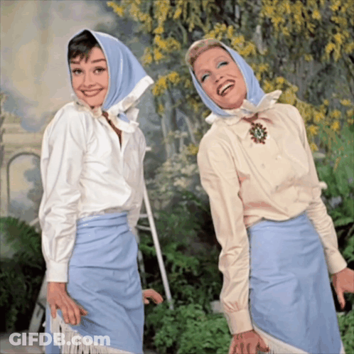 Two Women Posing One With Blue Scarf GIF