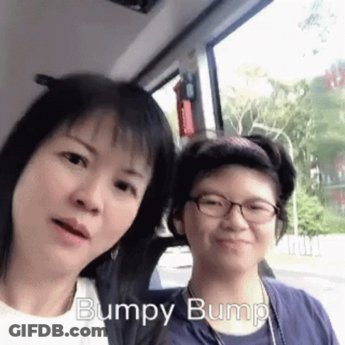 Two Women Posing One With Glasses One In Blue Shirt GIF