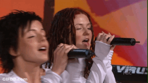 Two Women Singing Into Microphones At NBC Keyboard GIF