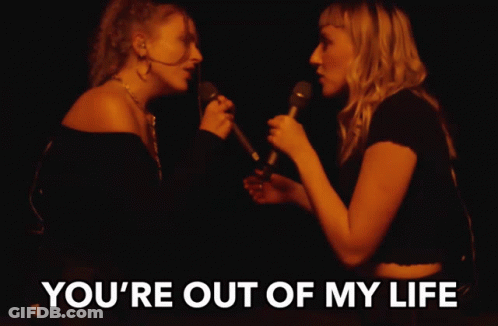 Two Women Singing Into Microphones With The Words " You 'Re Out Of My Life " Above Them GIF