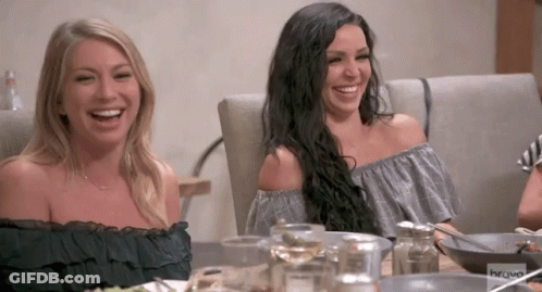 Two Women Sit At A Table With Bravo Written On The Bottom Of The Screen GIF