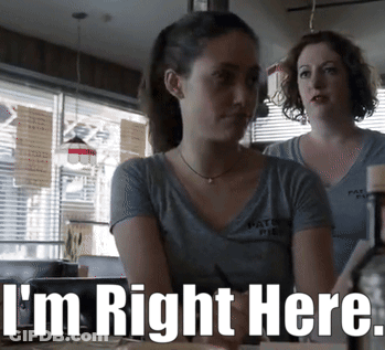 Two Women Sitting At Table Saying I'm Right Here GIF