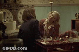 Two Women Sitting At Table Talking GIF
