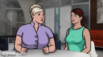 Two Women Sitting At Table Talking GIF