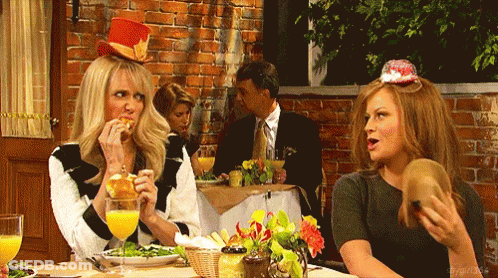 Two Women Sitting At Table With Man In Suit GIF