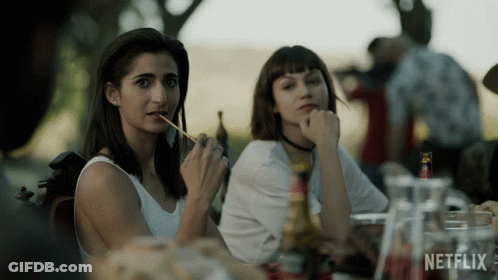 Two Women Sitting At Table With Netflix Bottle GIF