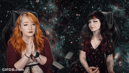Two Women Sitting Hands Folded In Front Of Galaxy Background GIF