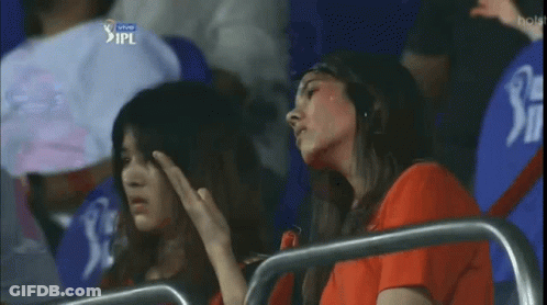 Two Women Sitting In A Stadium With Ipl Written On The Bottom GIF