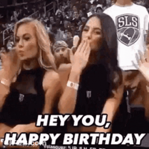 Two Women Sitting In Basketball Stands One Covering Mouth GIF