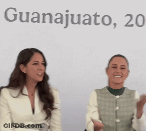 Two Women Sitting In Front Of Guanajuato Sign GIF