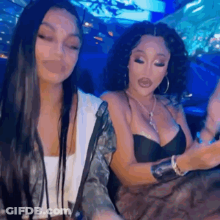 Two Women Sitting Next To Each Other In Restaurant GIF