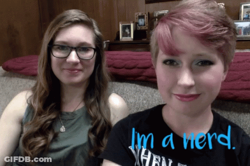 Two Women Sitting Next To Each Other Saying I'm A Nerd In Blue GIF