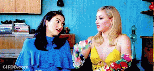 Two Women Sitting Next To Each Other Talking GIF