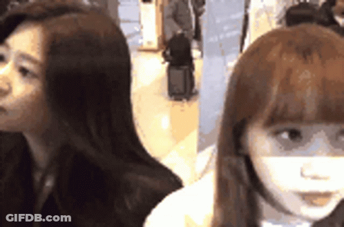Two Women Sitting Next To Each Other GIF