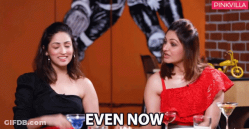 Two Women Sitting Next To Each Other With The Words Even Now Above Them GIF