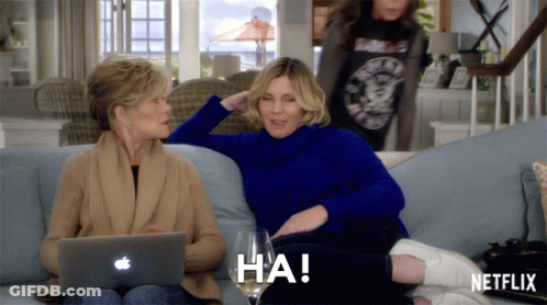 Two Women Sitting On A Couch With A Netflix Logo On The Bottom Right GIF