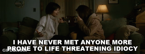 Two Women Sitting On A Couch With The Words " I Have Never Met Anyone More Prone To Life Threatening Idiocy " Below GIF