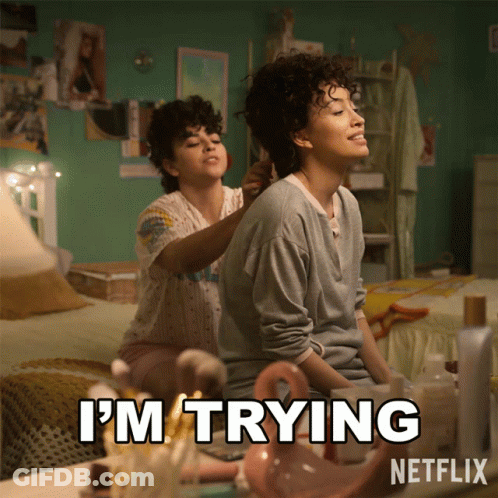 Two Women Sitting On Bed Saying I'm Trying GIF