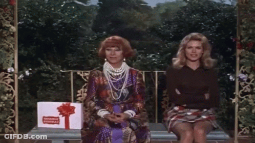 Two Women Sitting On Bench With Congratulations Gift Box GIF