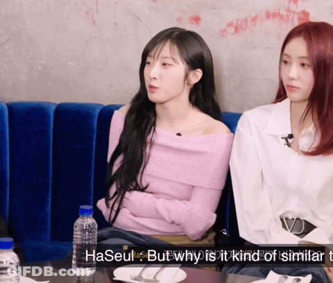 Two Women Sitting On Blue Couch GIF