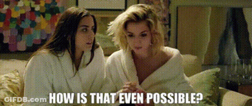Two Women Sitting On Couch Asking How Is That Possible GIF
