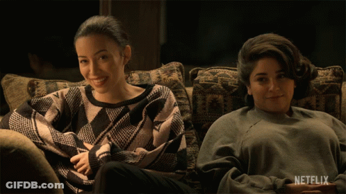 Two Women Sitting On Couch With Netflix Logo GIF