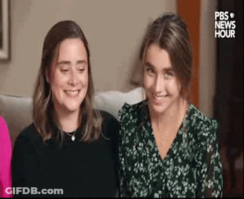 Two Women Sitting On Couch GIF