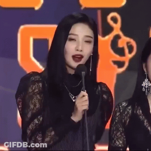 Two Women Smiling In Dark Room GIF