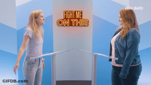 Two Women Stand In Front Of A Sign That Says " Fight Me On This " GIF