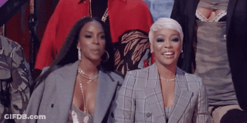 Two Women Standing And Smiling GIF