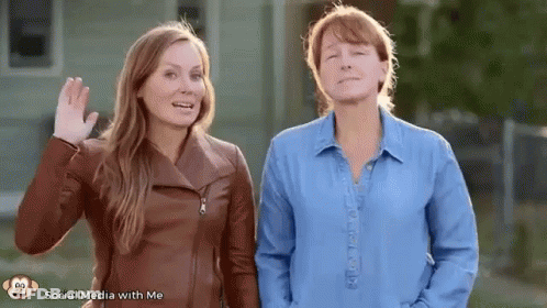 Two Women Standing And Waving GIF