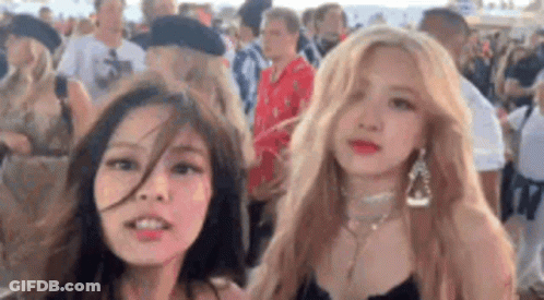 Two Women Standing At Festival GIF