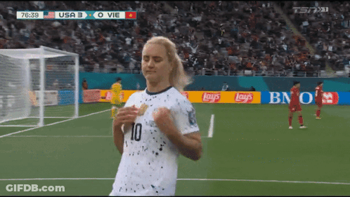 Two Women Standing By Brick Wall GIF